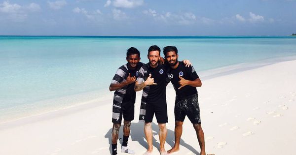 Foto: Adrián Gallardo, entre dos compañeros de equipo, en una playa de las Maldivas.