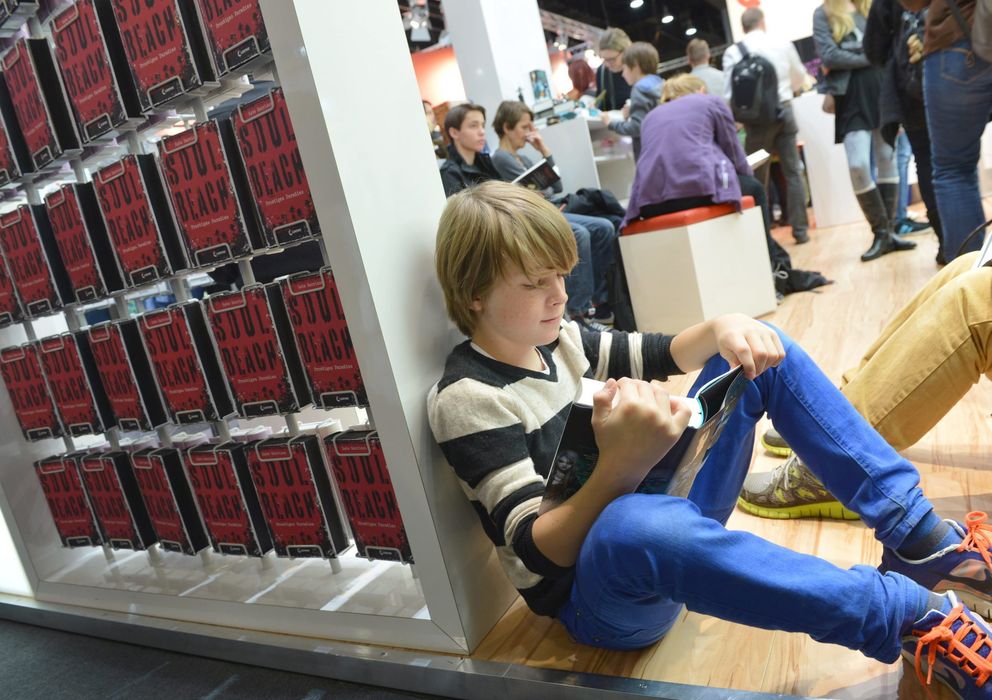 Foto: Un joven lee un libro en la feria de Frankfurt (EFE)