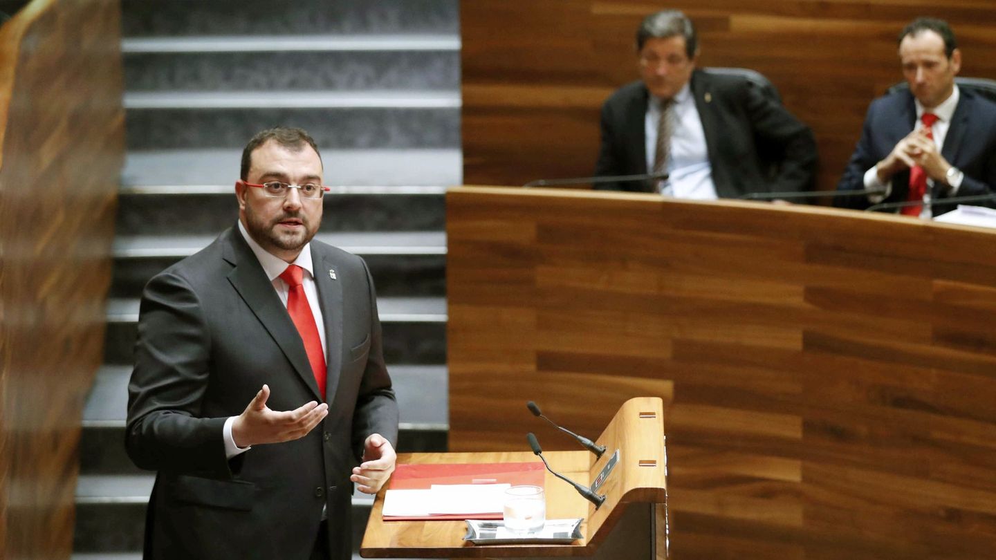 El presidente de Asturias, Adrián Barbón, en el Parlamento. Al fondo, Javier Fernández. (EFE)