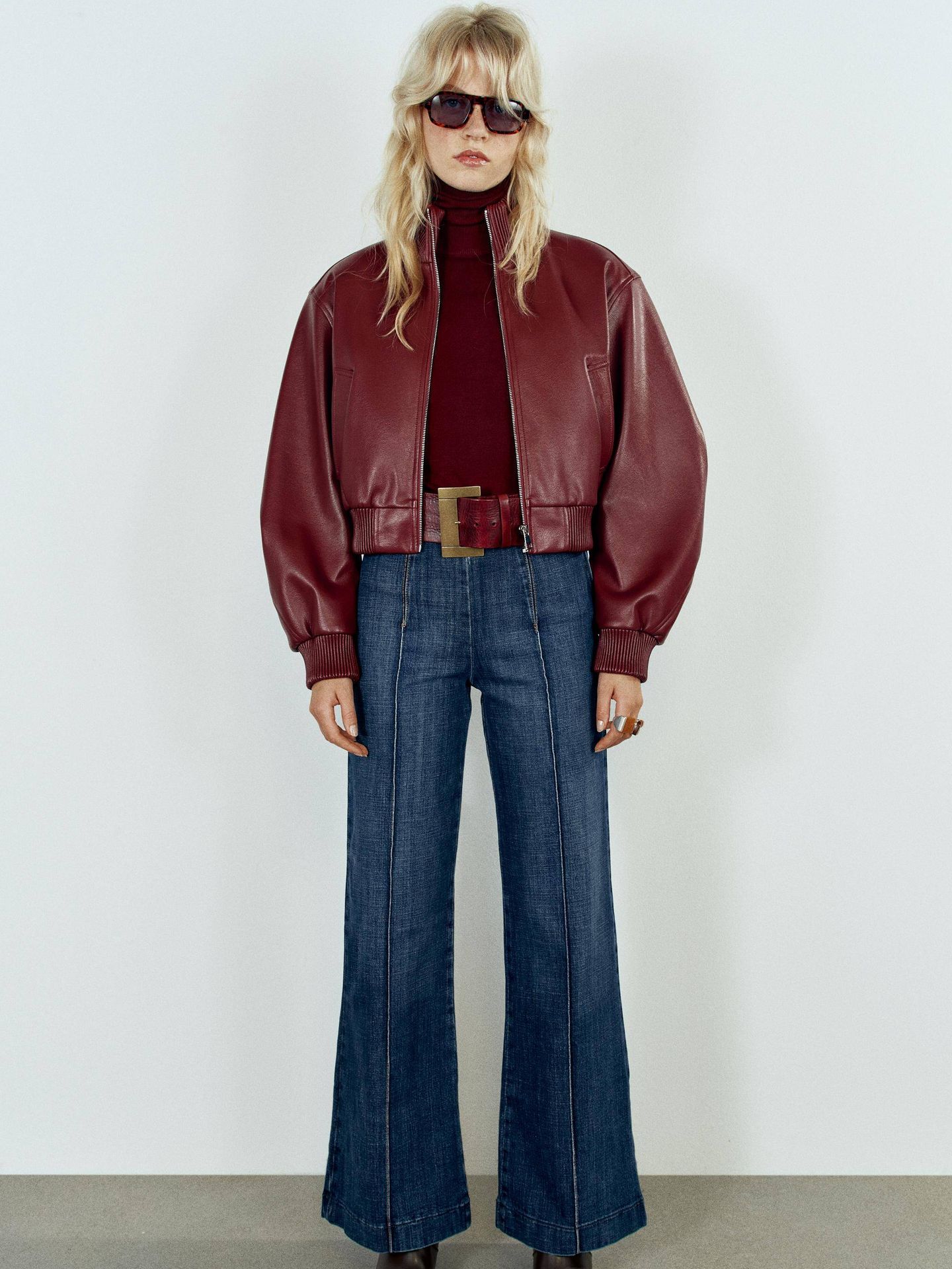 La bomber burdeos aporta fuerza a un look con vaqueros de pernera ancha. (Cortesía / Zara)