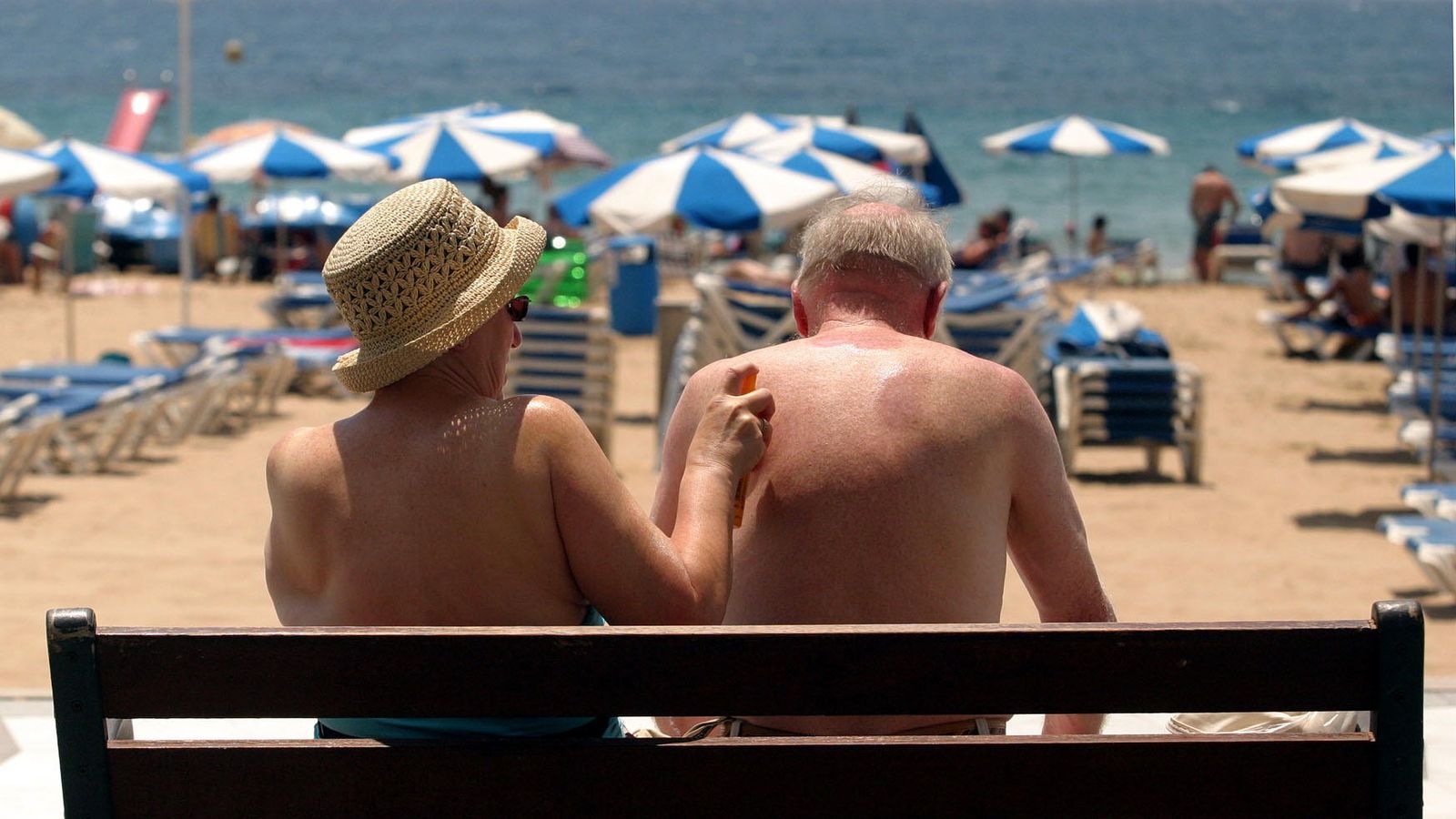 Foto: Una pareja de turistas se echa crema en Benidorm (EFE)