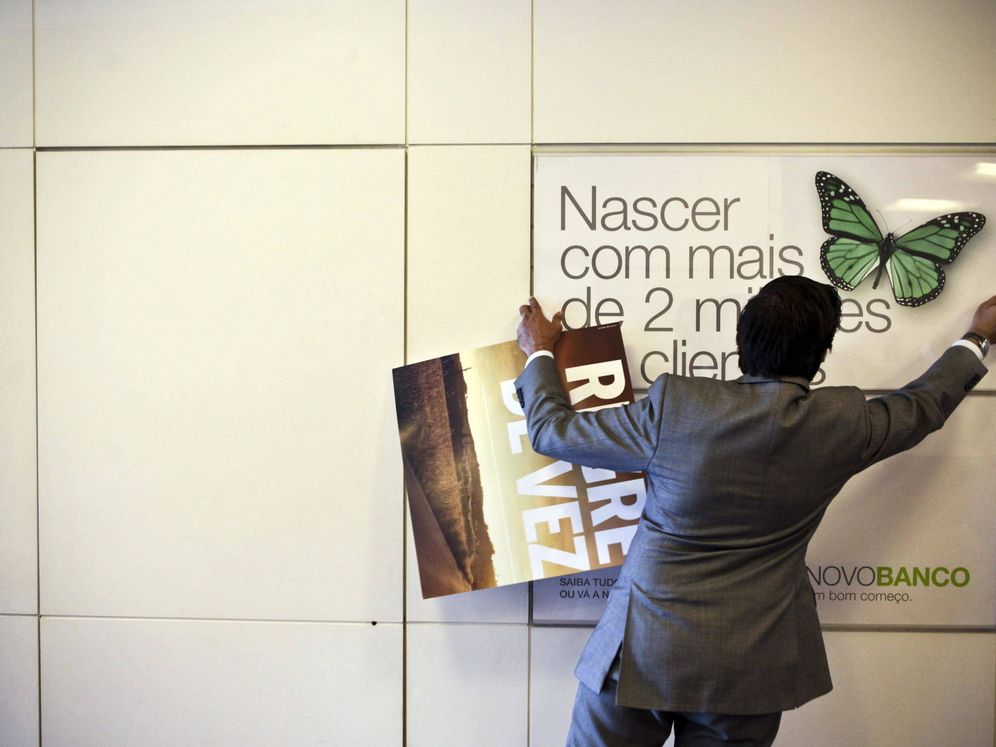 Foto: Un hombre cambia una imagen en una sucursal de Novo Banco. (Reuters)