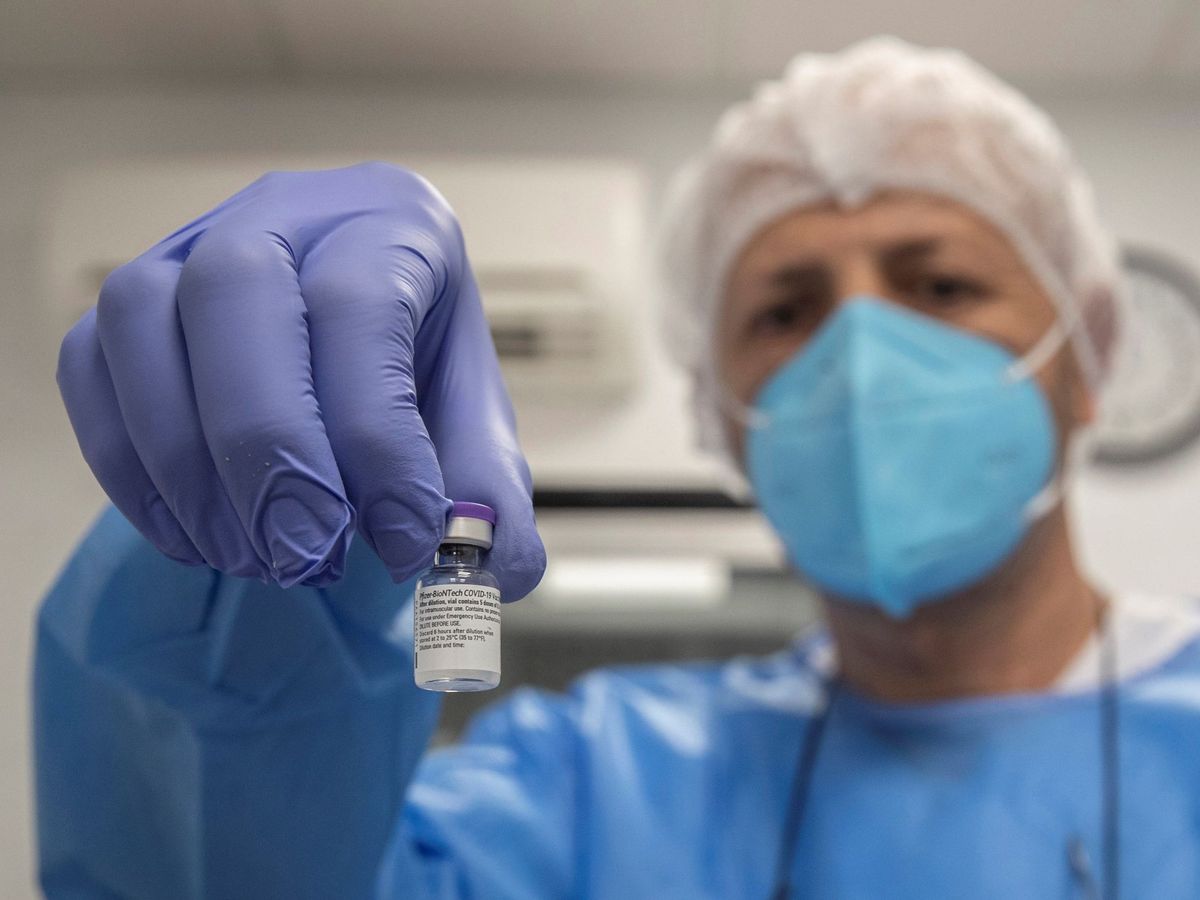 Foto: Un enfermero de la armada española muestra un vial de la vacuna. (EFE)