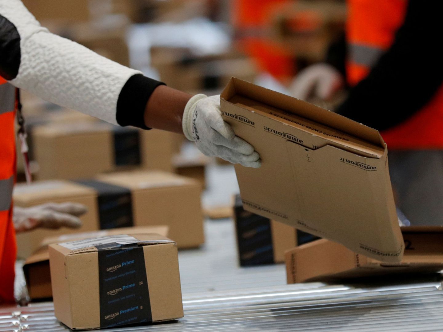 FILE PHOTO: Employees sort packages at the Amazon distribution center warehouse in Saran, near Orleans, France, November 22, 2016. REUTERS Philippe Wojazer File Photo