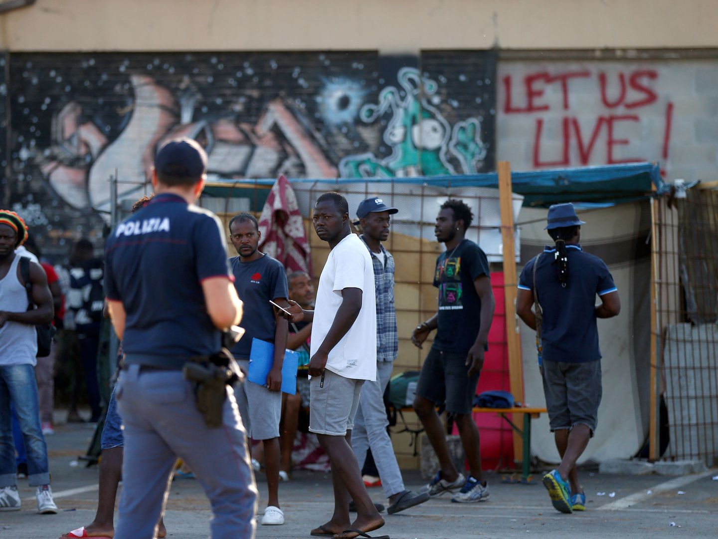 La policía italiana identifica a inmigrantes en un campamento cerca de Roma. (Reuters)
