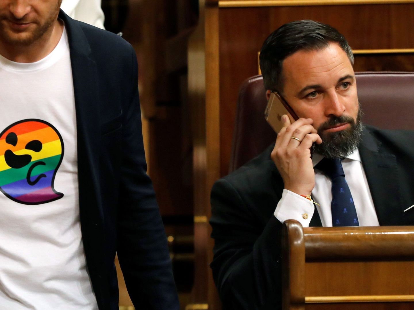 Arnau Ramirez, con una camiseta con el icono Gaysper, pasa ante el presidente de Vox, Santiago Abascal. (EFE)