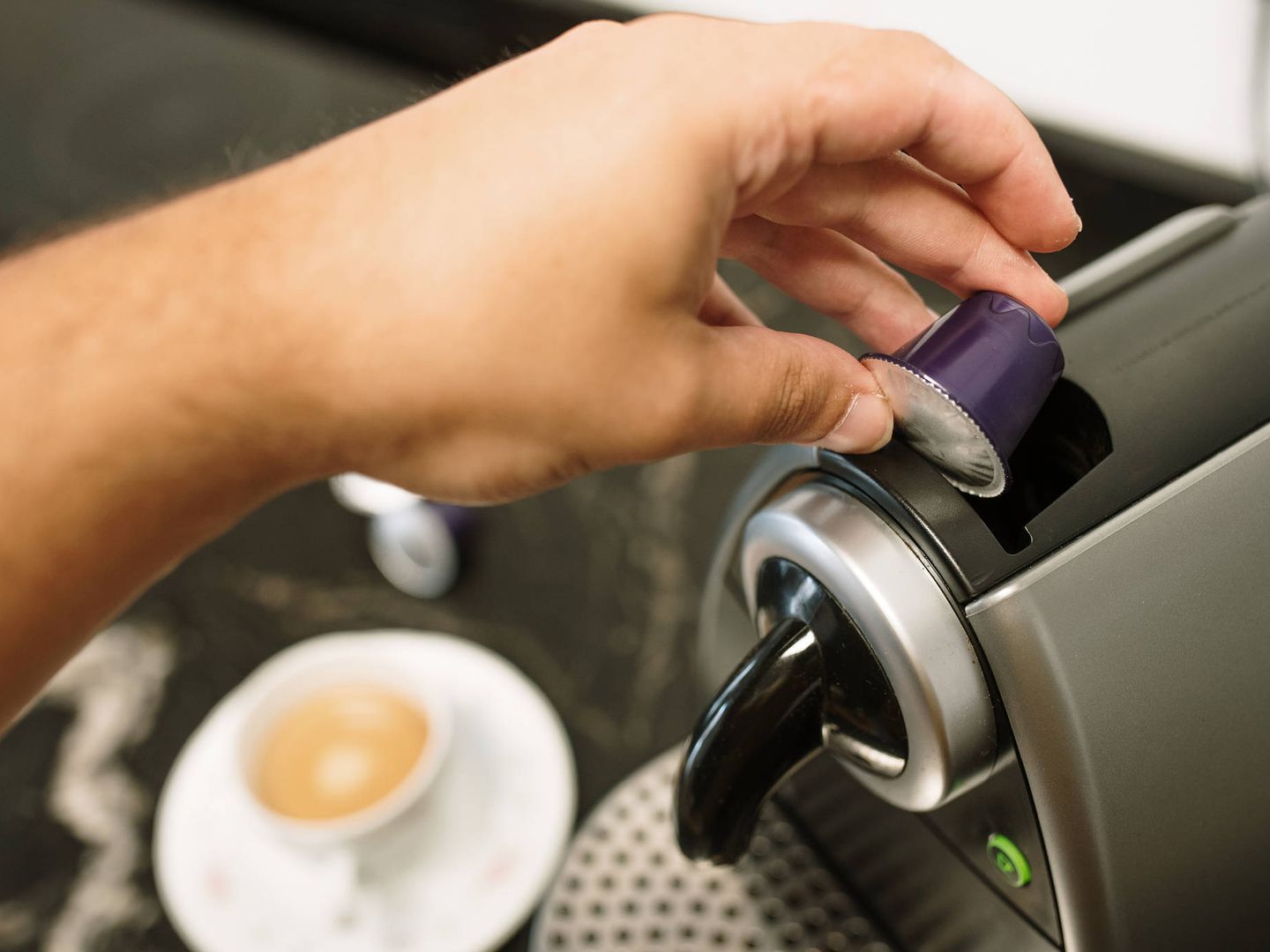 Una persona hace café en una máquina que funciona con cápsulas (iStock)
