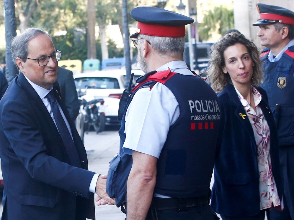 Foto: Quim Torra saluda a un agente de los Mossos en el Parlament. (EFE)