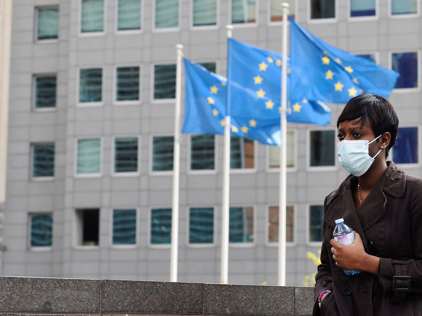 Una mujer con mascarilla cerca de la sede de la Comisión Europea en Bruselas. (Reuters)