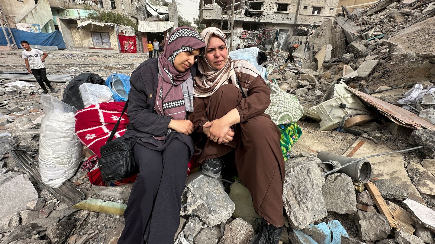Palestinian women react as they sit on the rubble of a residential building housing their apartments, following an Israeli raid, amid the ongoing conflict between Israel and the Palestinian Islamist group Hamas, in Nuseirat, in the central Gaza Strip, April 18, 2024. REUTERS Doaa Rouqa
