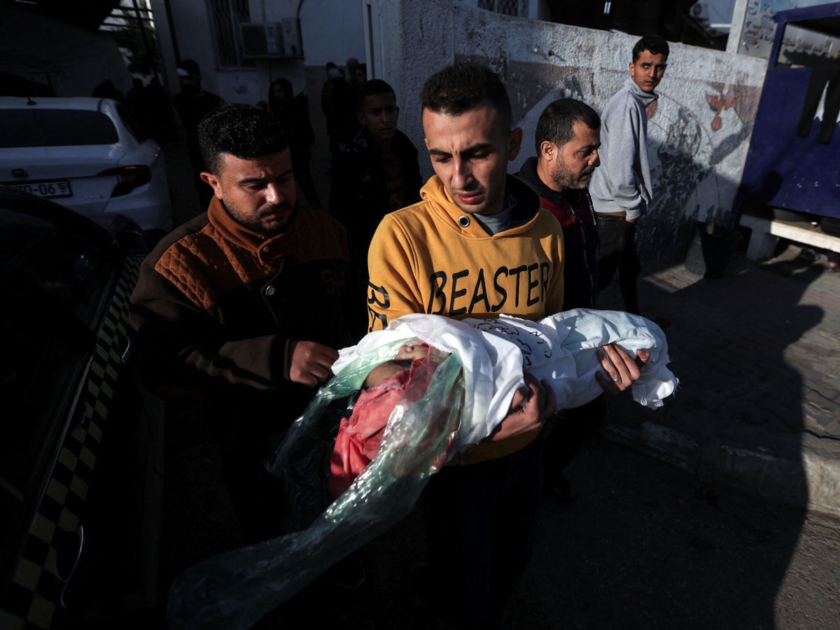 Foto: Un gazatí sostiene el cuerpo de un niño muerto por un bombardeo israelí el mes pasado. (Reuters/Ibraheem Abu Mustafa)