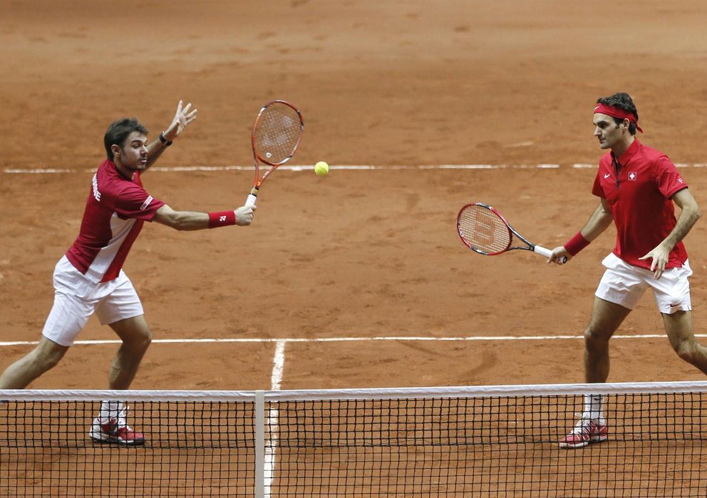 Foto: Wawrinka prepara su volea de derecha ante la mirada de Federer. 