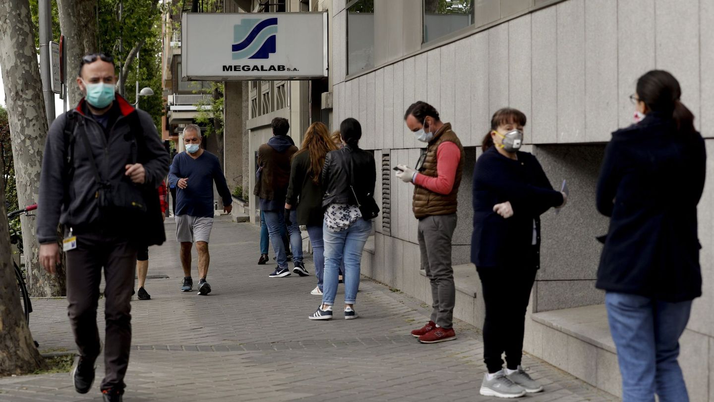 Varias personas hacen cola para someterse a un test para detectar el coronavirus en los laboratorios de Megalab en Madrid en la desescalada de mayo de 2020. (EFE)