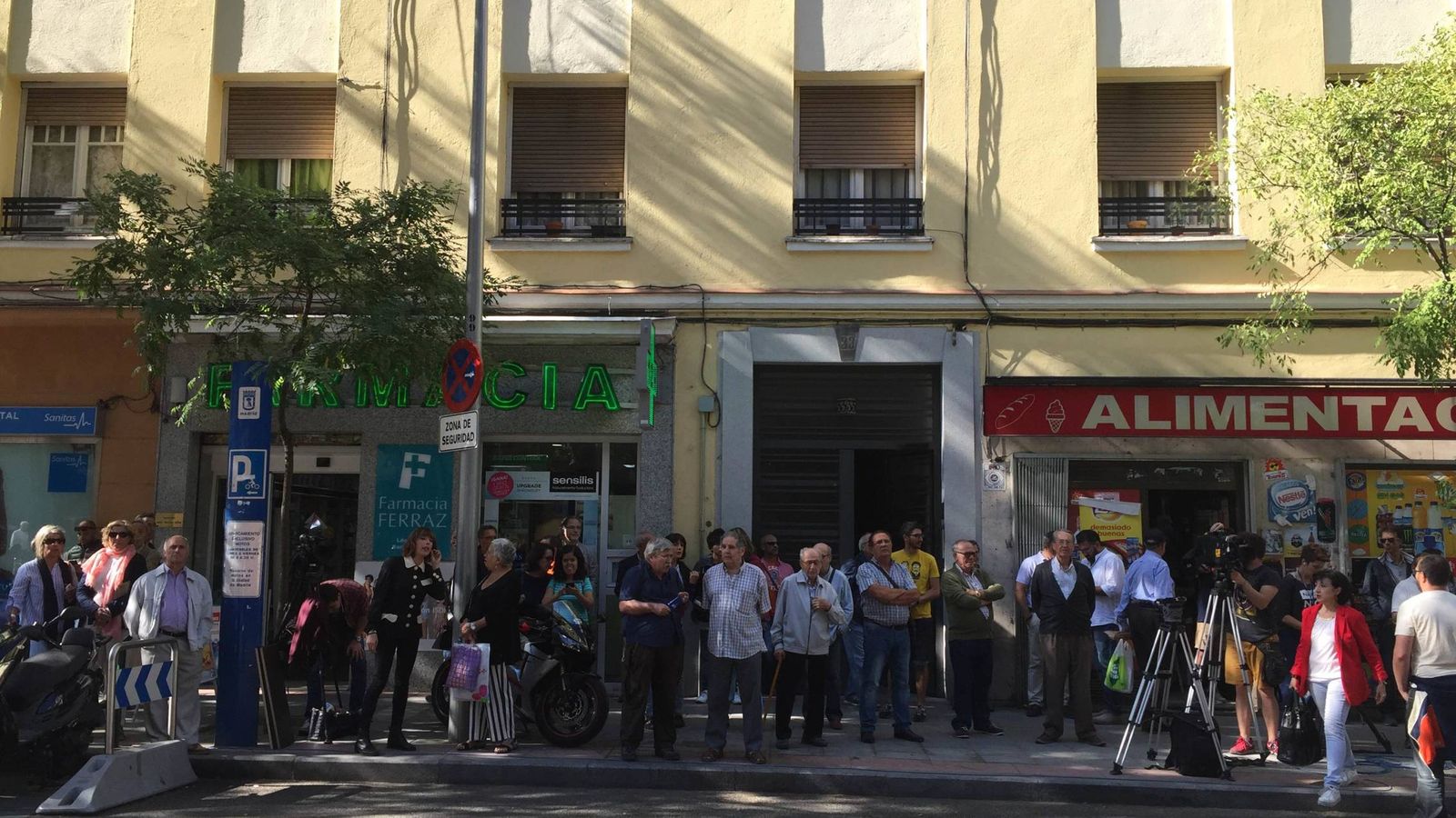 Foto: Vecinos, curiosos y votantes del PSOE junto a la sede del PSOE en la calle Ferraz de Madrid. (EC)