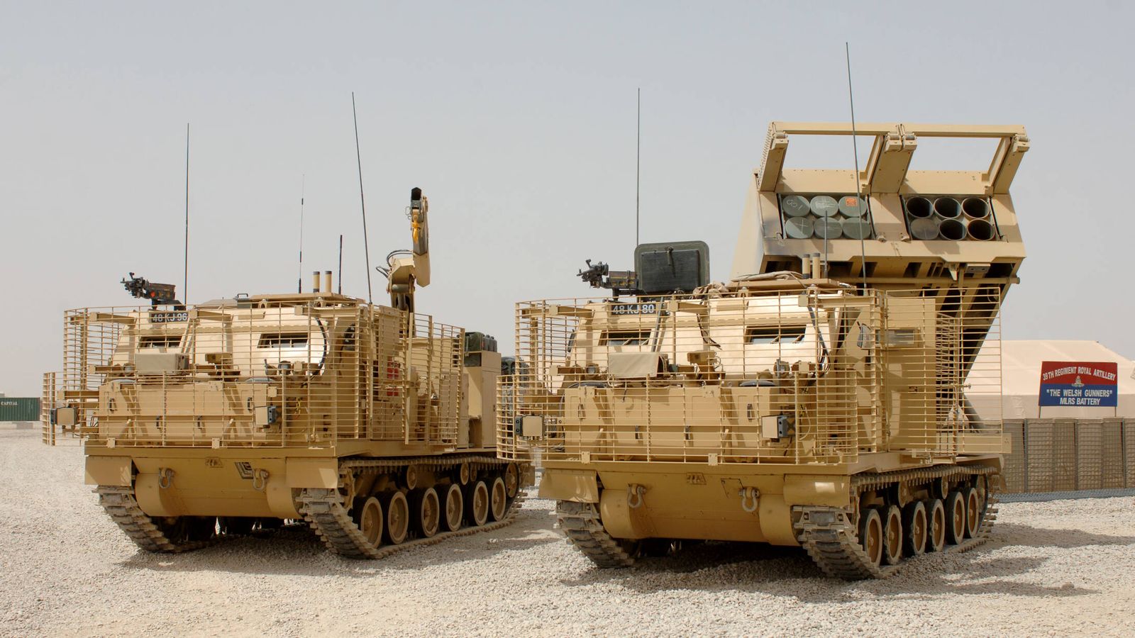 MLRS M270 (derecha) británico en Afganistán. El vehículo de la izquierda se utiliza para recargar los módulos de cohetes. (UK MoD)