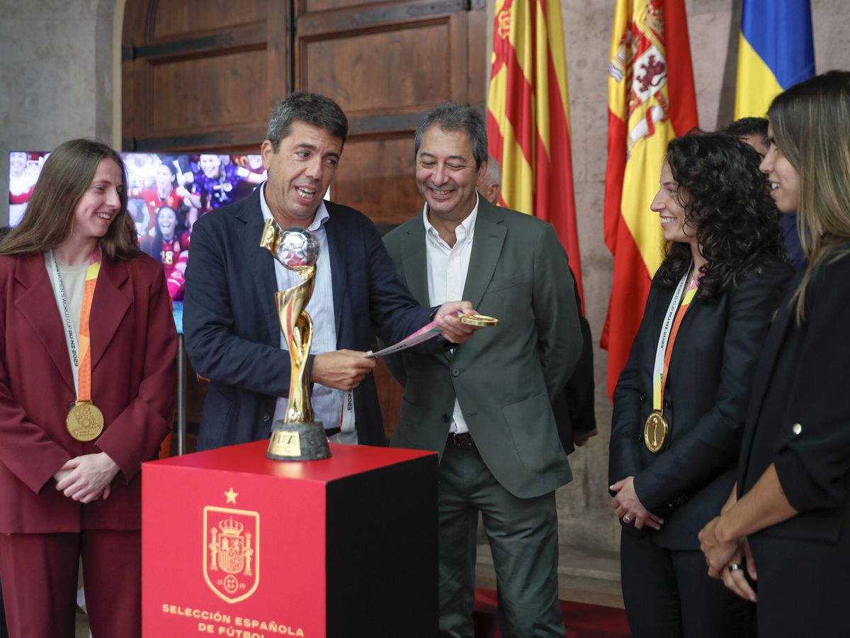 Foto: Las jugadoras valencianas, con Mazón y Vicente Barrera. (EFE/Juan Carlos Cárdenas) 
