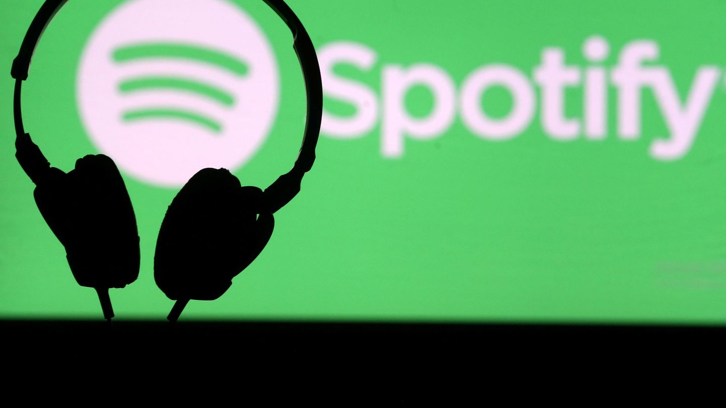 FILE PHOTO: A headset in front of a screen projection of Spotify logo, in this picture taken April 1, 2018. REUTERS Dado Ruvic File Photo