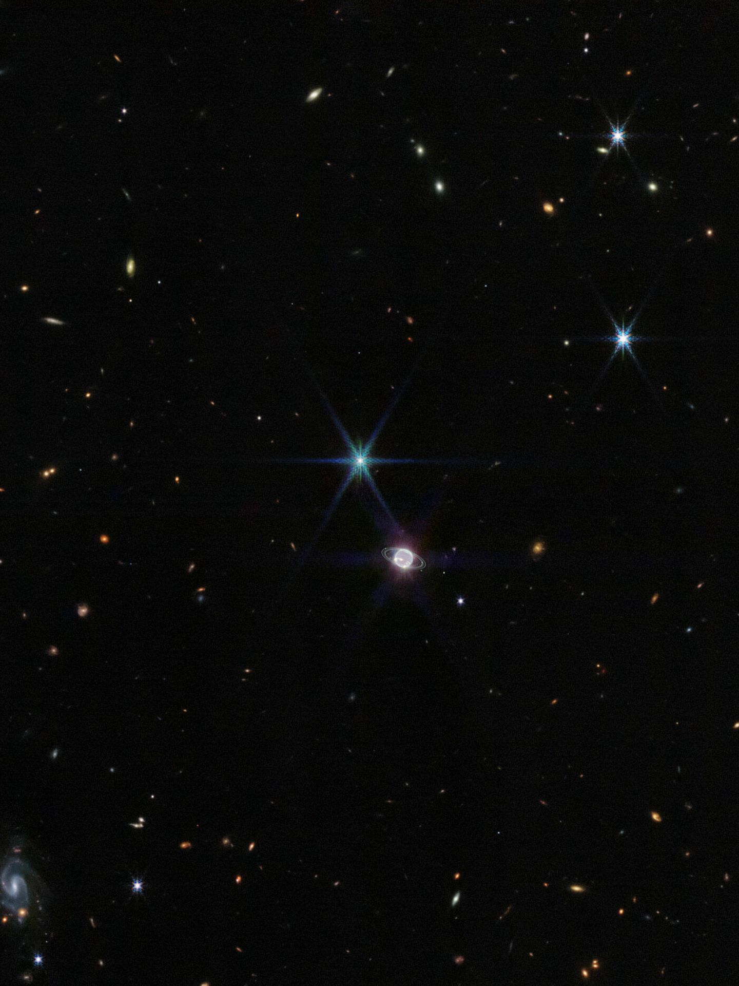Imagen completa del James Webb, mostrando Neptuno contra un fondo de galaxias. (NASA)