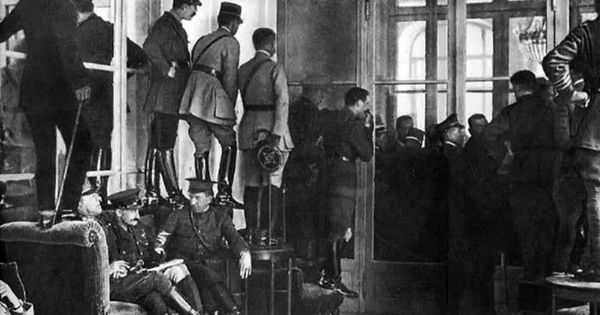 Foto: Oficiales y políticos se suben a los muebles para observar la firma del Tratado de Versalles tras la Primera Guerra Mundial el 28 de junio de 1919.