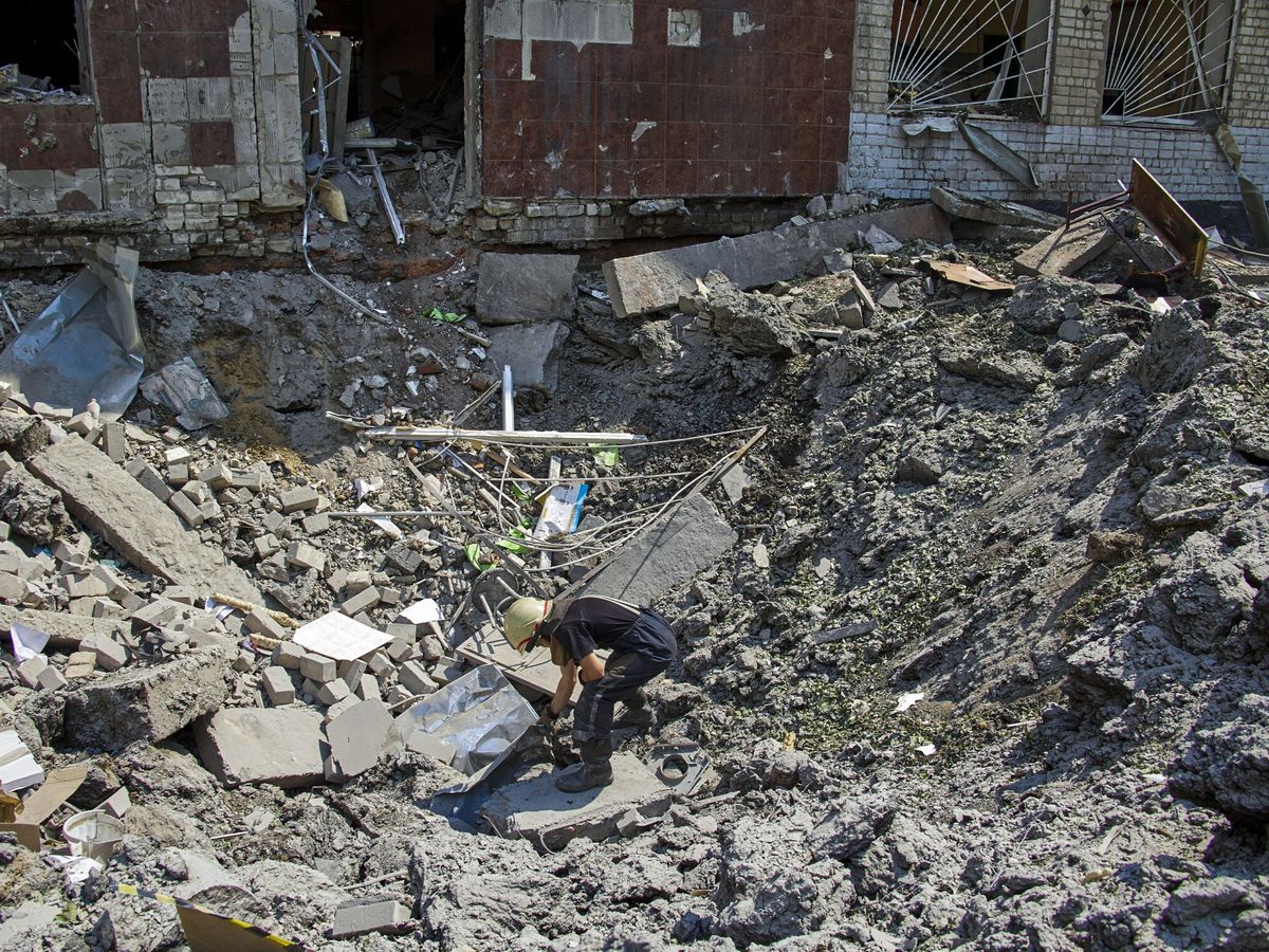 Foto: Rescatistas ucranianos limpian los escombros de una escuela afectada por un bombardeo en Járkov, Ucrania. (EFE/EPA/Sergey Kozlov) 