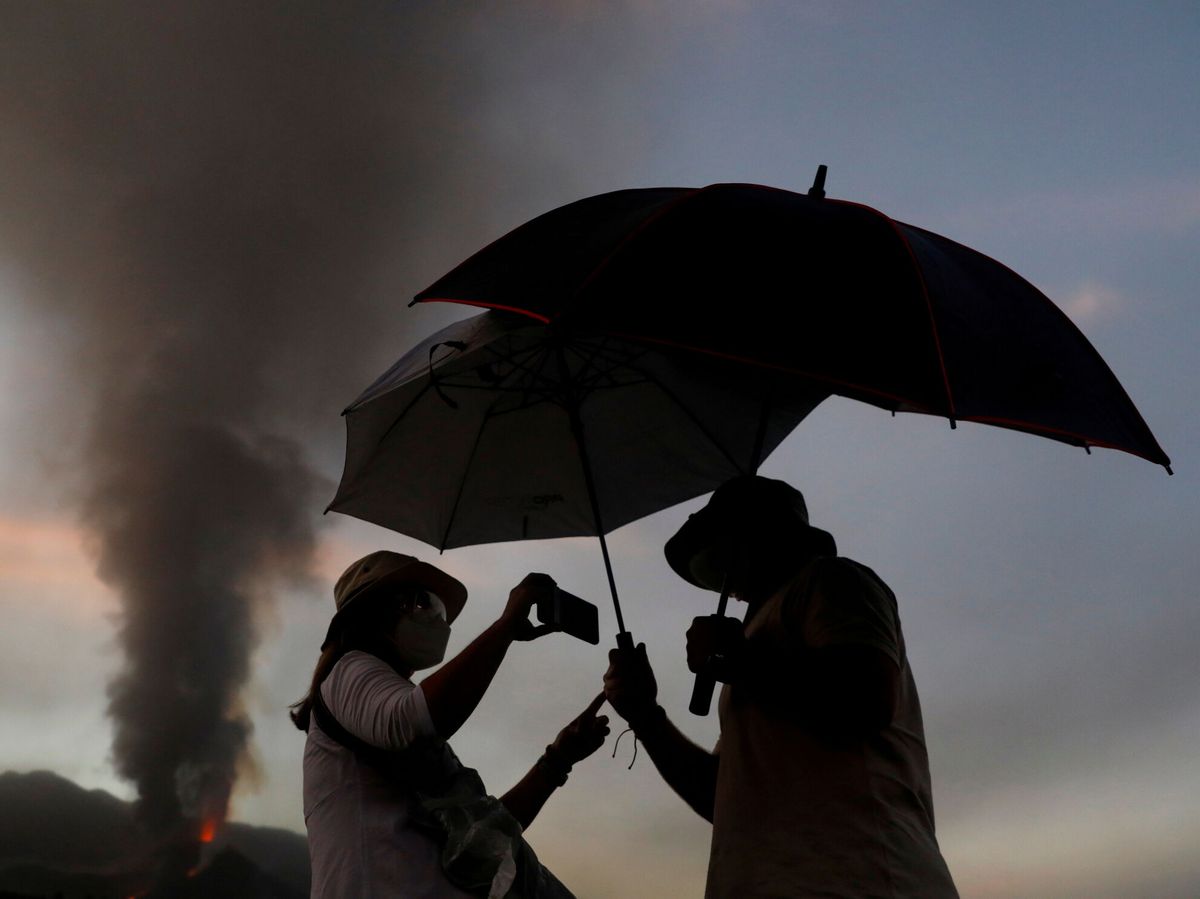 Foto: Una pareja se fotografía con la erupción del volcán de fondo (REUTERS/Vera)