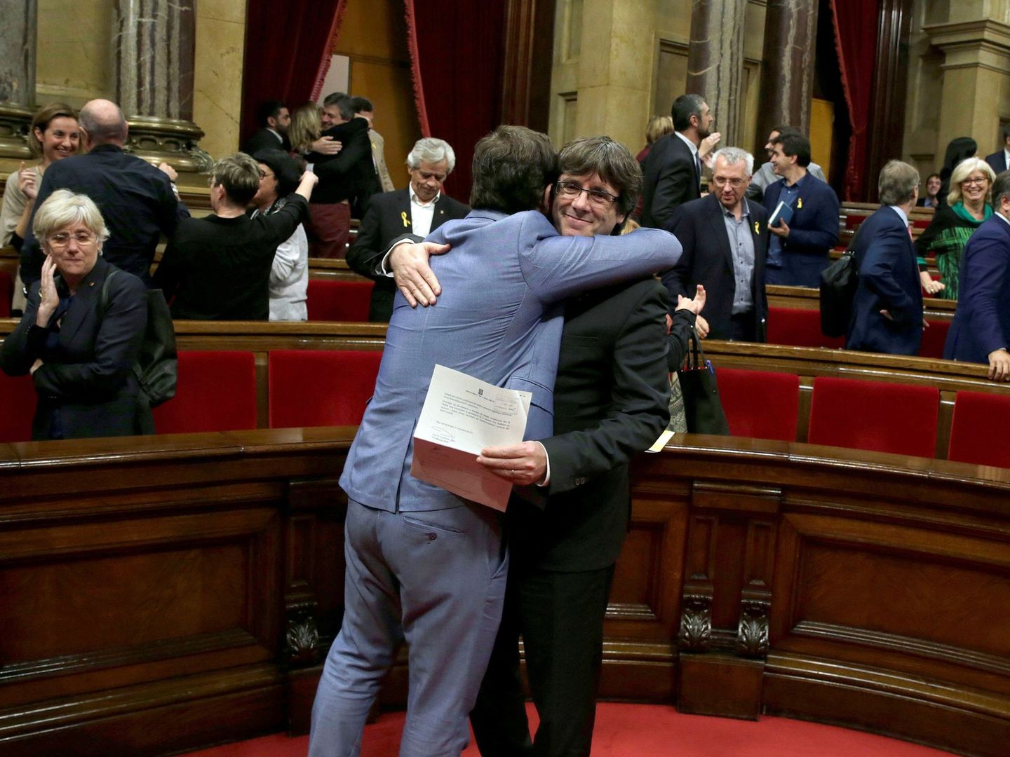 Carles Puigdemont es abrazado tras votar y aprobar la presunta aprobación de la DUI. (EFE)