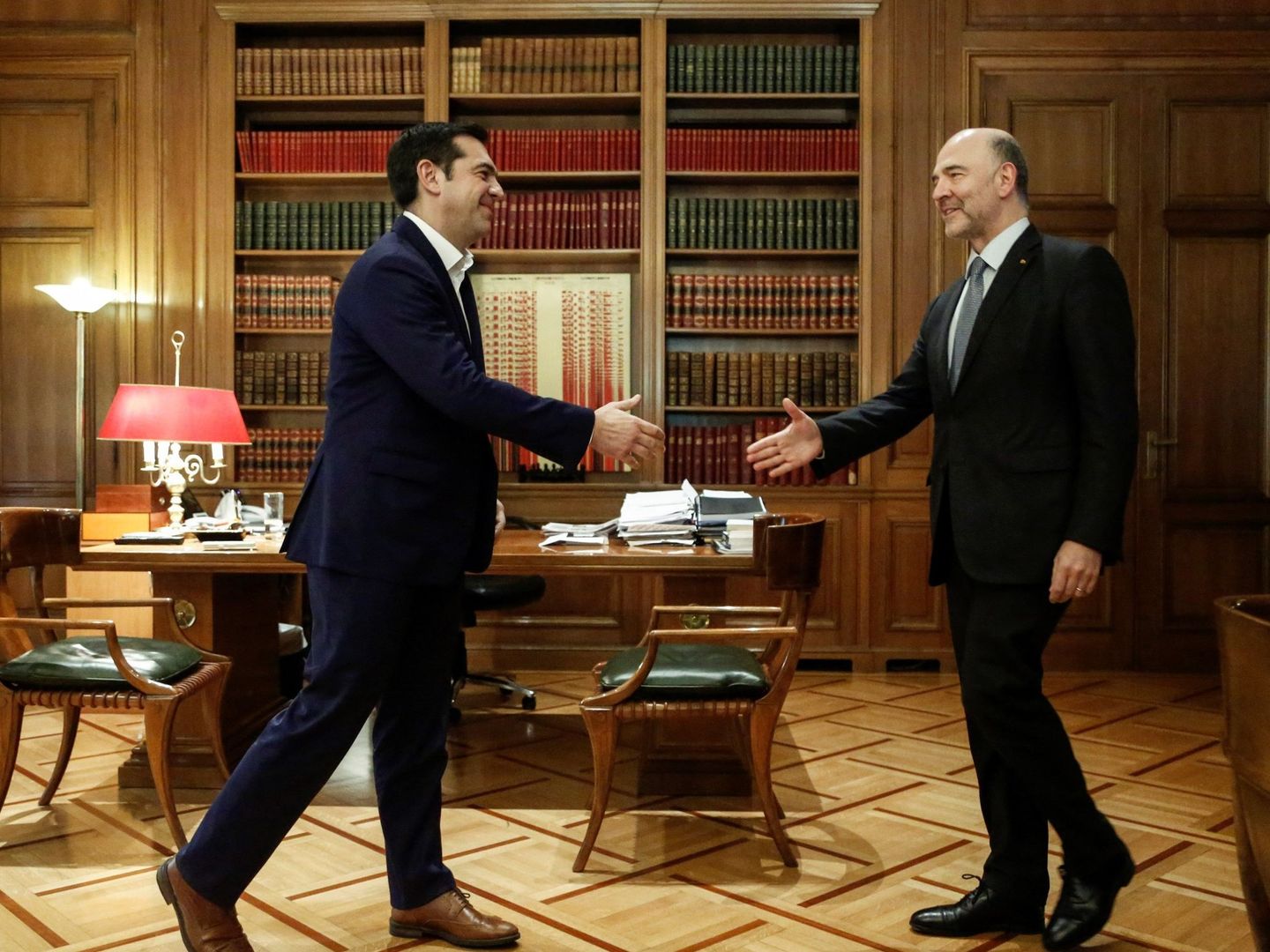 Tsipras saluda a Moscovici en su visita a Atenas, en la que le echó un buen capote, para enfado de los conservadores. (EFE)