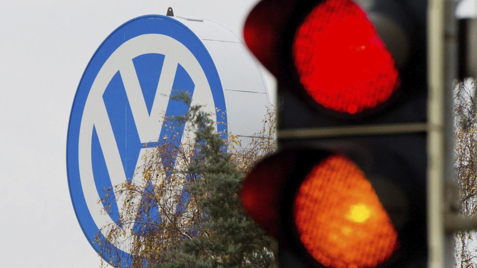 Foto: Logotipo de Volkswagen junto a un semáforo en rojo y naranja en Fallersleben (Alemania). (EFE)