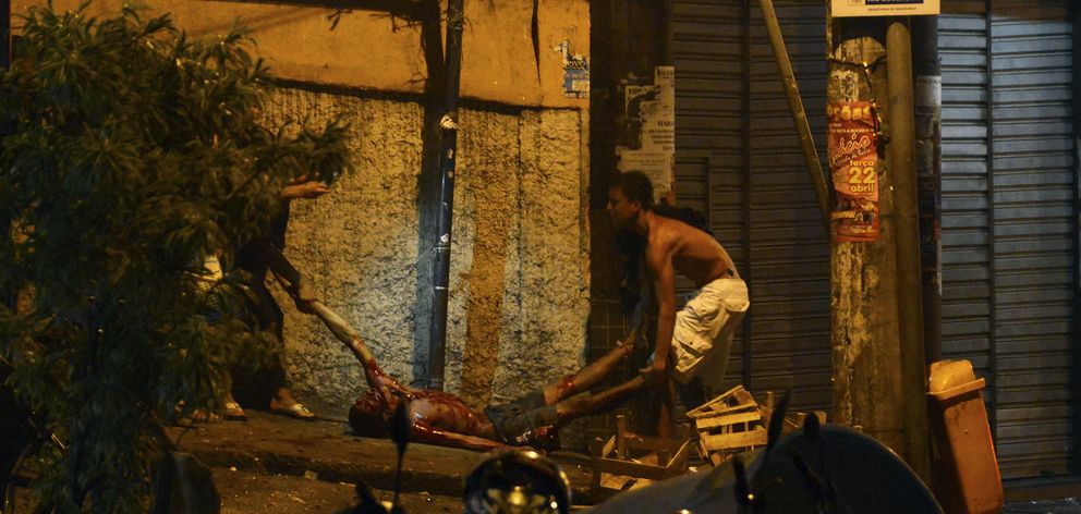 Residentes de la favela Pavao-Pavaozinho ayudan a un herido en las protestas (Reuters).