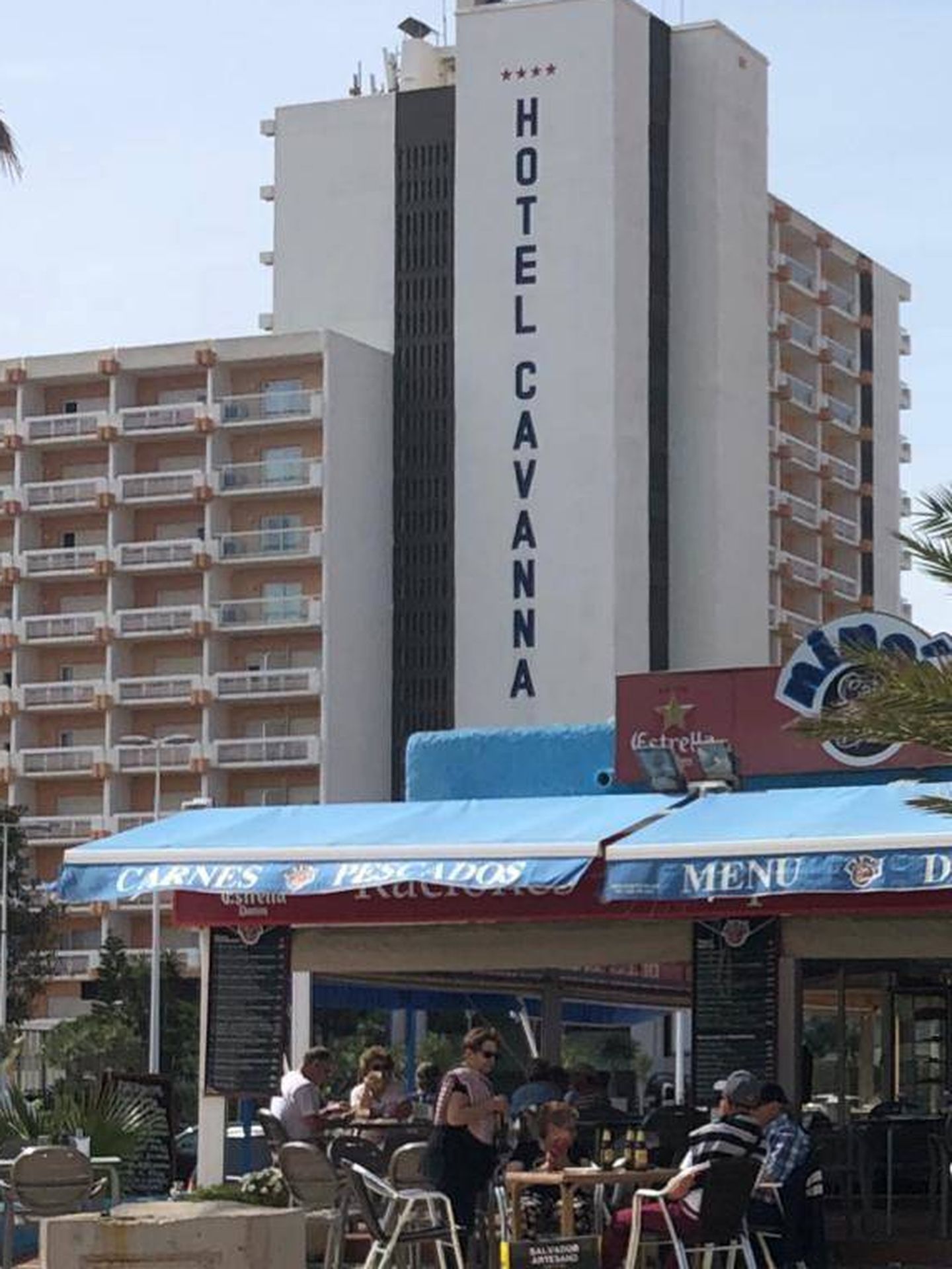 Hotel Cavanna de fondo y una terraza repleta de clientes, en La Manga. (Foto: Lucía Meca)
