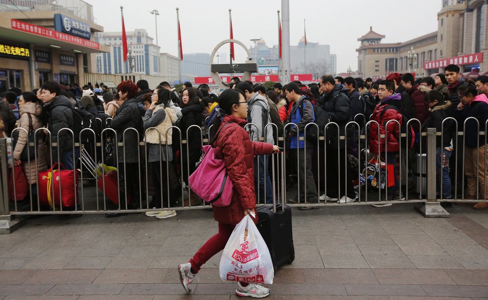 Una multitud hace cola para entrar en una estación de tren en Pekín (Reuters). 