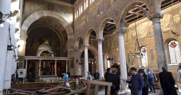 Foto: Varias personas comprueban los daños en el interior de la Iglesia de San Pedro, tras un atentado reivindicado por el ISIS el pasado fin de semana. (EFE)