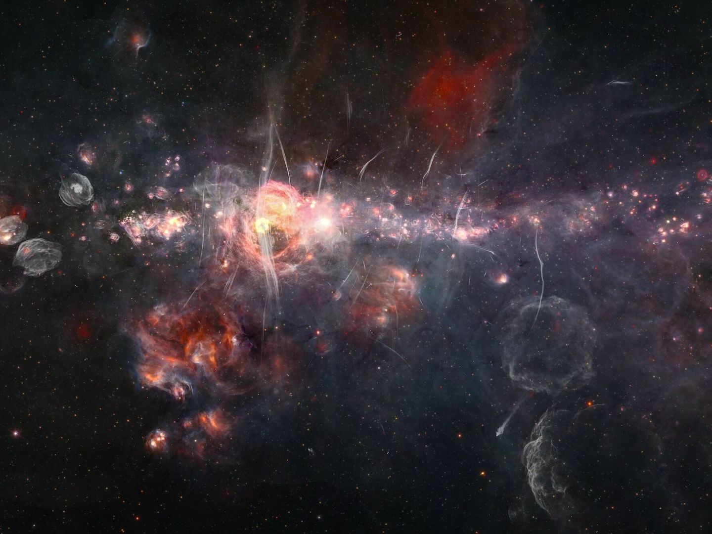 El centro de nuestra galaxia combiando datos del mosaico infrarrojo Spitzer/WISE con el estudio de ondas de radio MeerKAT. (Judy Schmidt)