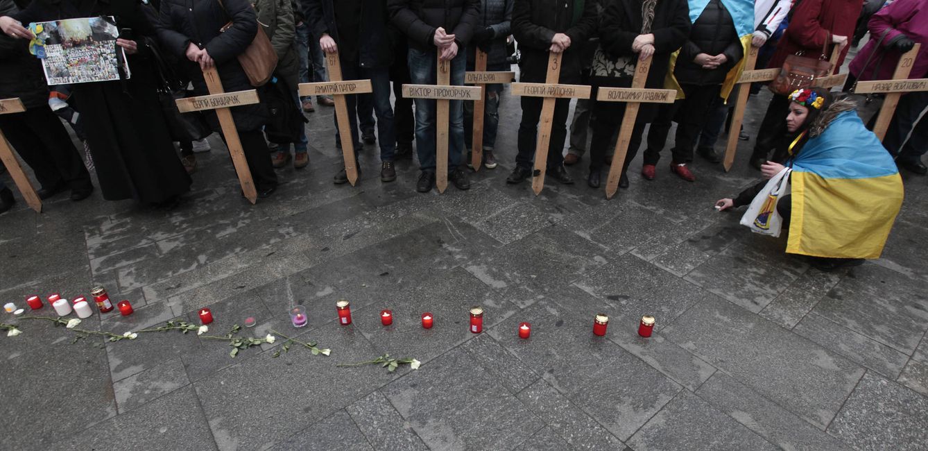 Una mujer coloca velas durante un homenaje a los muertos en la revolución del Maidán, en Kiev. (Reuters)