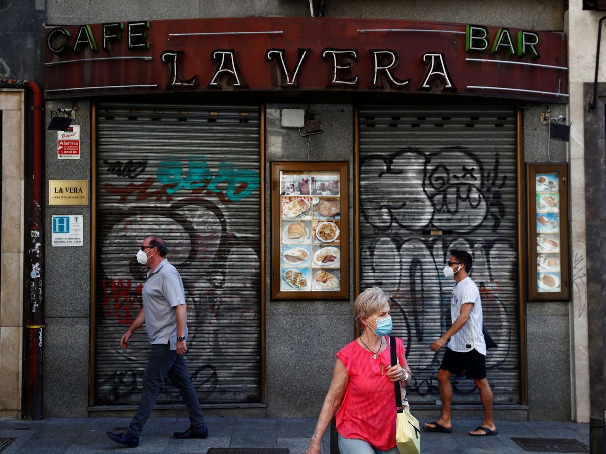 Foto: Tres personas con mascarillas en Madrid. (Reuters)
