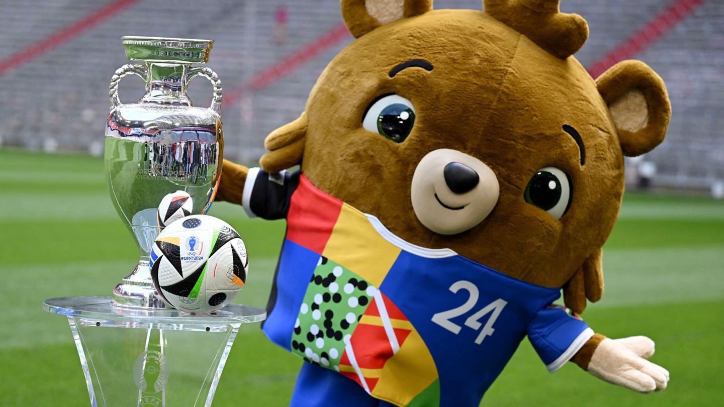 Soccer Football - Euro 2024 - Trophy Display at Allianz Arena, Munich, Germany - May 13, 2024 Euro 2024 mascot Albart poses with the European Championship trophy REUTERS Angelika Warmuth