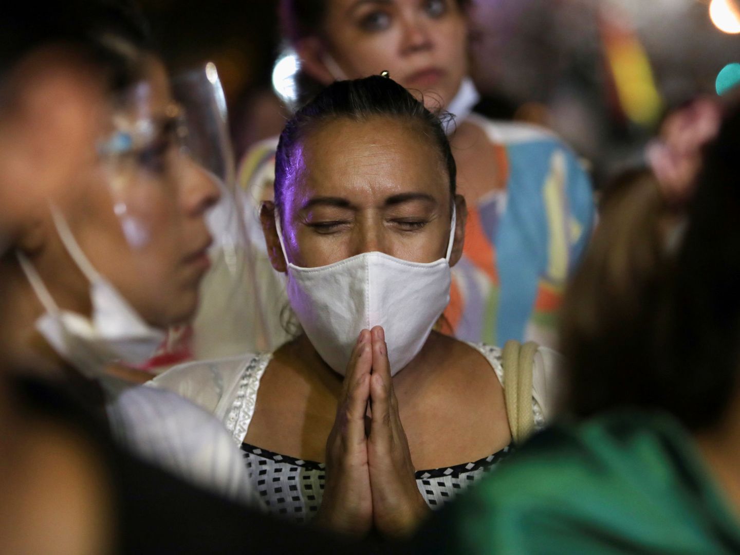 A demonstrator prays as she takes part in a rally to protest against Bolivian President Luis Arce's government after the detention of former interim President Jeanine Anez, in Santa Cruz, Bolivia, March 15, 2021. REUTERS Lesly Moyano  NO ARCHIVE NO RESALES
