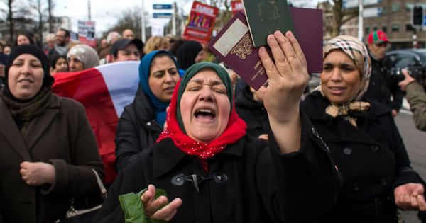 Foto: Una mujer muestra sus pasaportes marroquí y holandés durante una protesta contra Geert Wilders en Amsterdam. (Reuters)