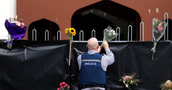 Foto: Un oficial de policía coloca flores en la entrada de la mezquita Masjid Al Noor, 