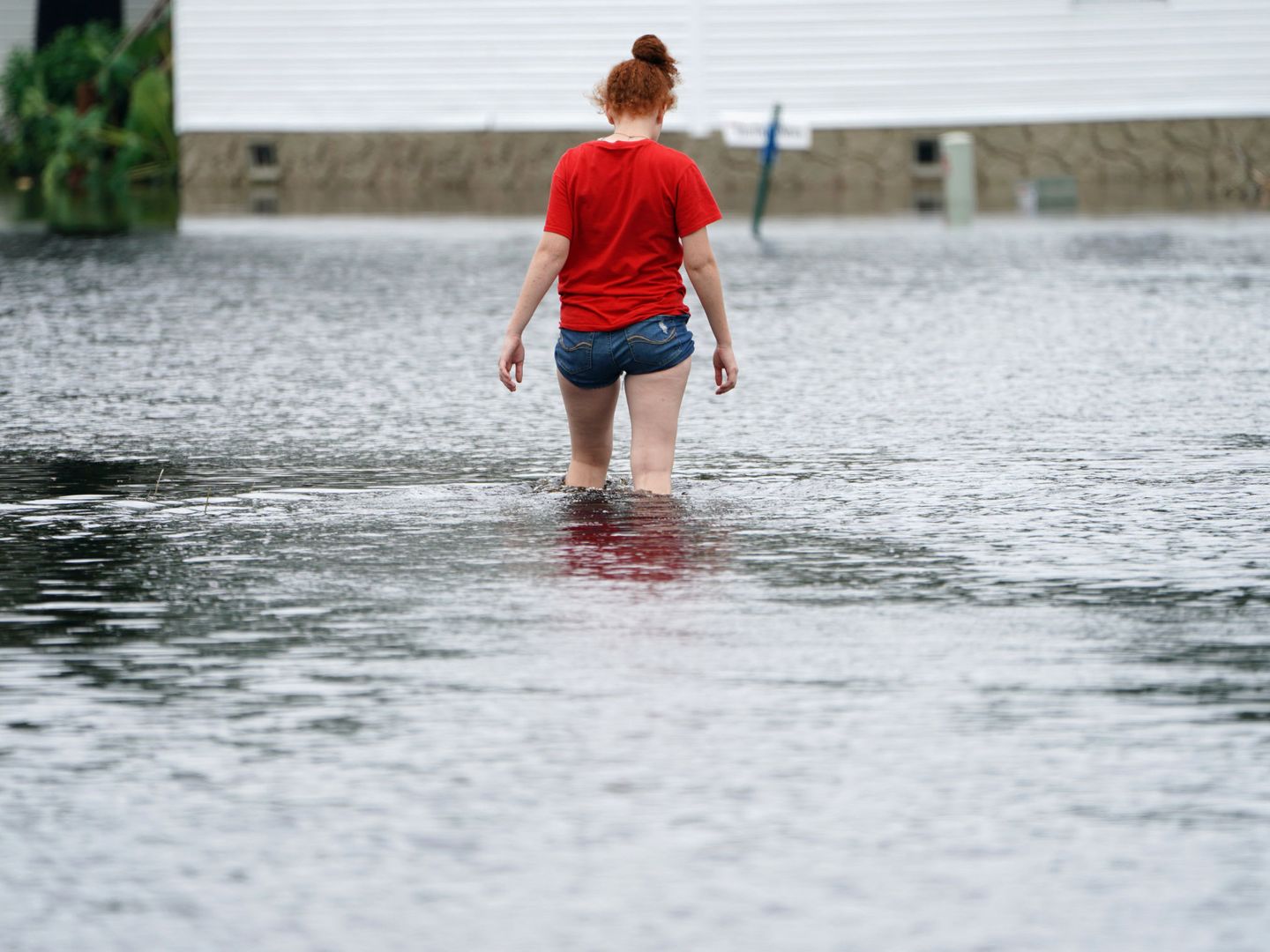 A person walks through a flooded street after Hurricane Florence struck Piney Green, North Carolina, U.S., September 16, 2018. REUTERS Carlo Allegri