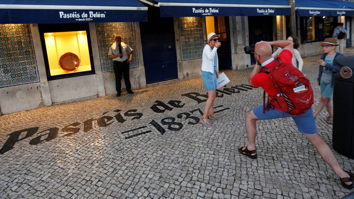 Un grupo de turistas se hace foto frente al famoso café Pastéis de Belem en Lisboa. (Reuters)