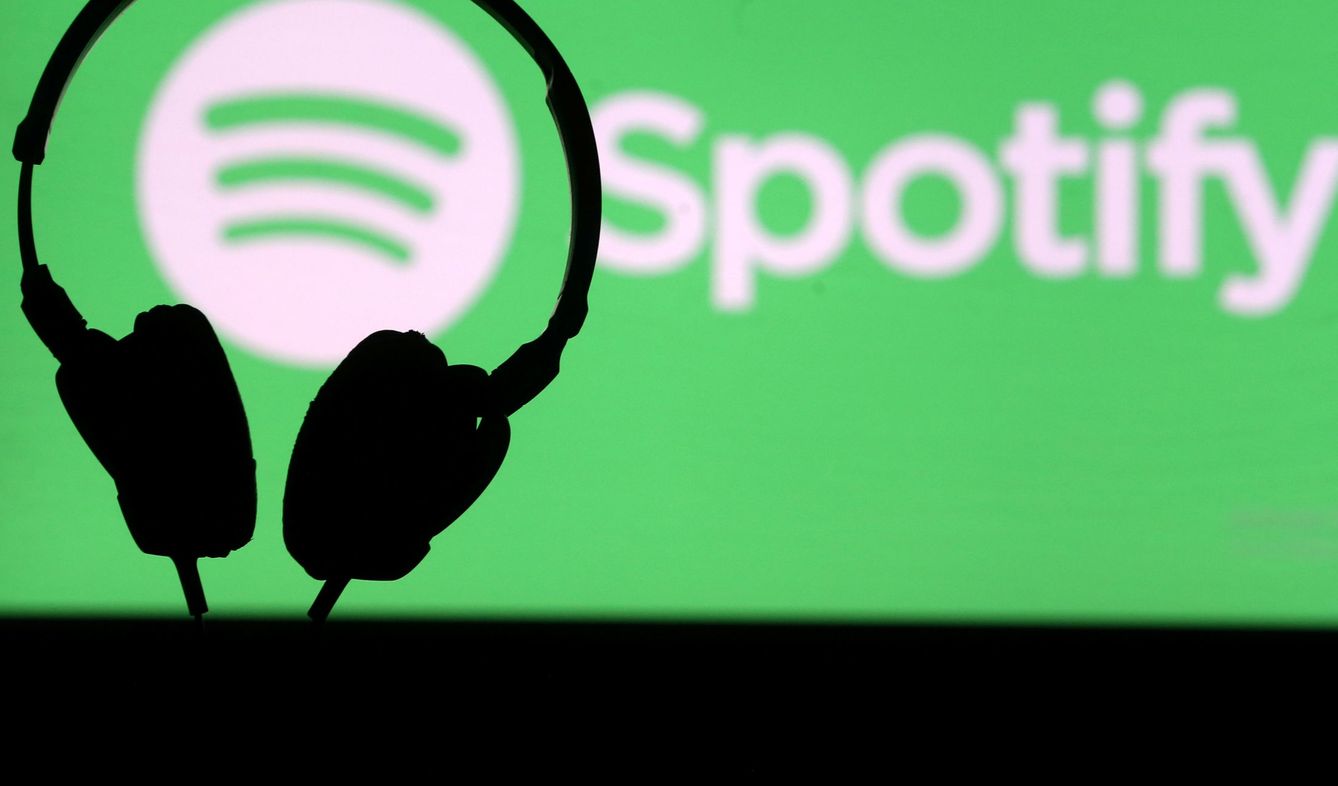FILE PHOTO: A headset in front of a screen projection of Spotify logo, in this picture taken April 1, 2018. REUTERS Dado Ruvic File Photo