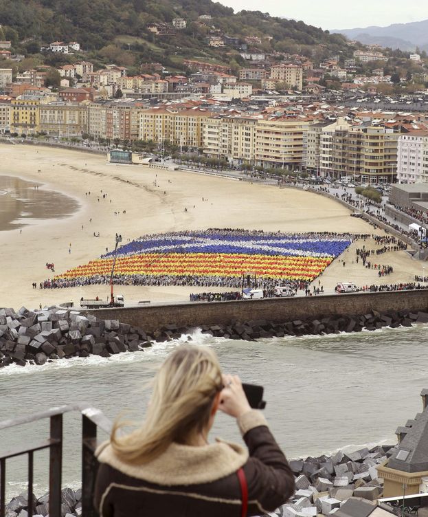 Foto: Gure Esku Dago construye un mosaico gigante con la señera y la bandera escocesa en la playa de la Zurriola de San Sebastián por el derecho a decidir. (EFE)