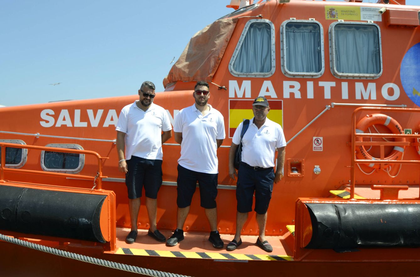 Manolo (centro) junto a dos compañeros en la zona del barco desde donde suben a los rescatados. (M. Z.)