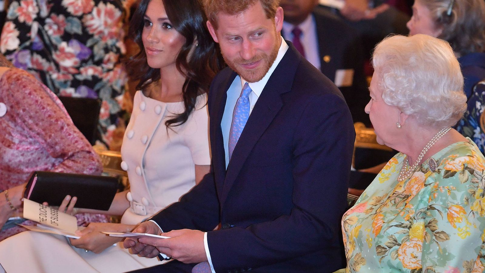 Foto: Meghan con su bolso, Harry y la reina Isabel II. (Gtres)