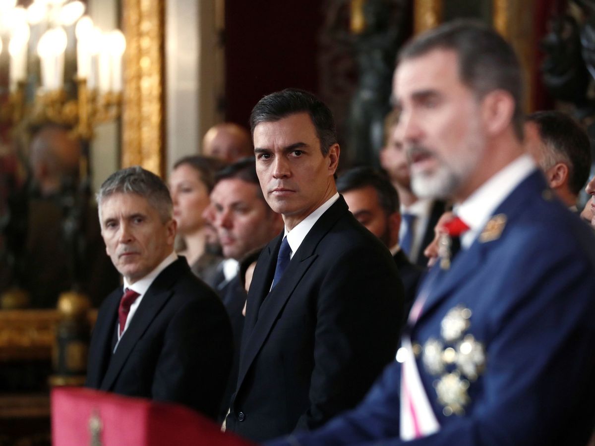 Foto: Pedro Sánchez y el ministro del Interior en funciones, Fernando Grande-Marlaska, escuchan al Rey durante su discurso en la Pascua Militar, este 6 de enero. (EFE)