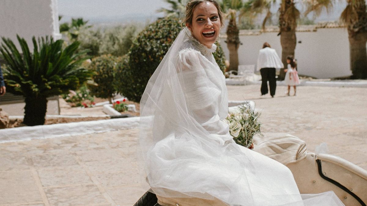 La boda de Virginia en Málaga y su vestido de novia desmontable con capa y escote asimétrico