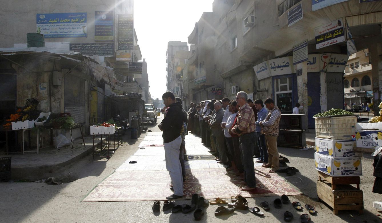 Hombres orando fuera de sus tiendas en Raqqa, en abril de 2014 (Reuters)