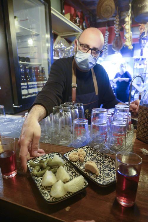 Un camarero sirve una tapa en un bar de Granada. (EFE/Miguel Ángel Molina)