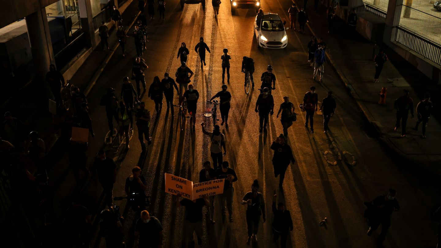Protesters march as they enter a tunnel a day after a grand jury considering the March killing of Breonna Taylor, a Black medical worker, in her home in Louisville, Kentucky, voted to indict one of three white police officers for wanton endangerment, in Louisville, Kentucky, U.S. September 24, 2020. REUTERS Carlos Barria
